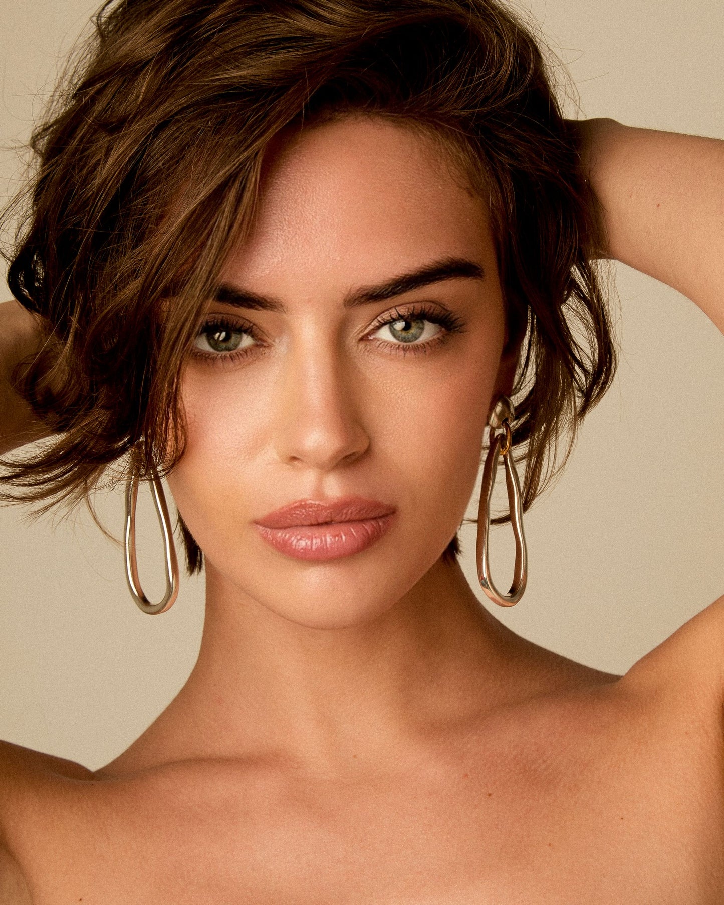 Model wearing 24k gold and Sterling Silver plated teardrop link earrings by Vidda Jewelry.