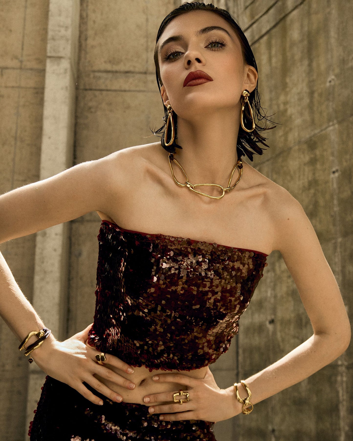 
                  
                    Model styling 24k gold teardrop link earrings with matching Vidda Jewelry pieces for a complete look.
                  
                