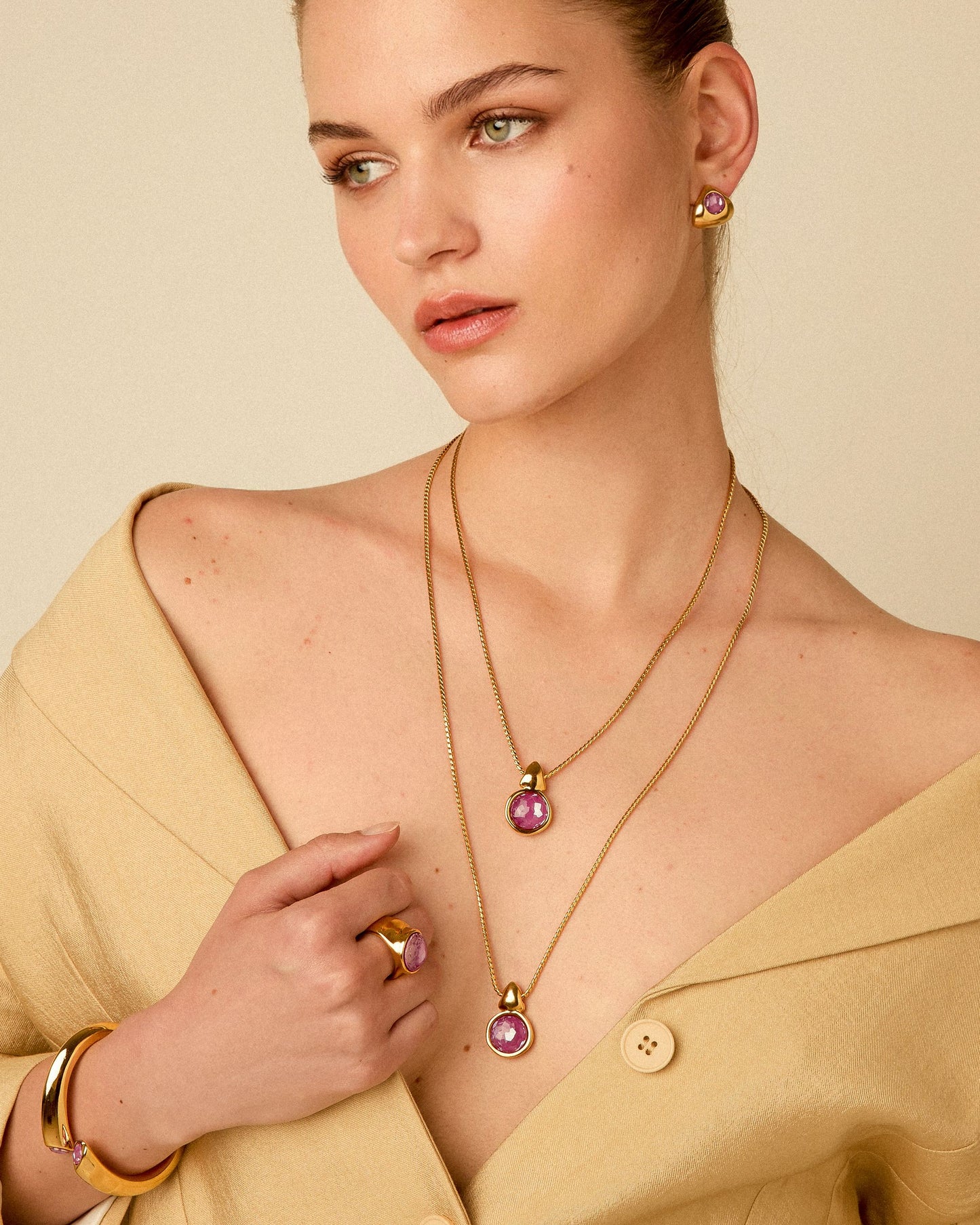 
                  
                    Triangle earrings with crystal styled with matching gold jewelry pieces
                  
                