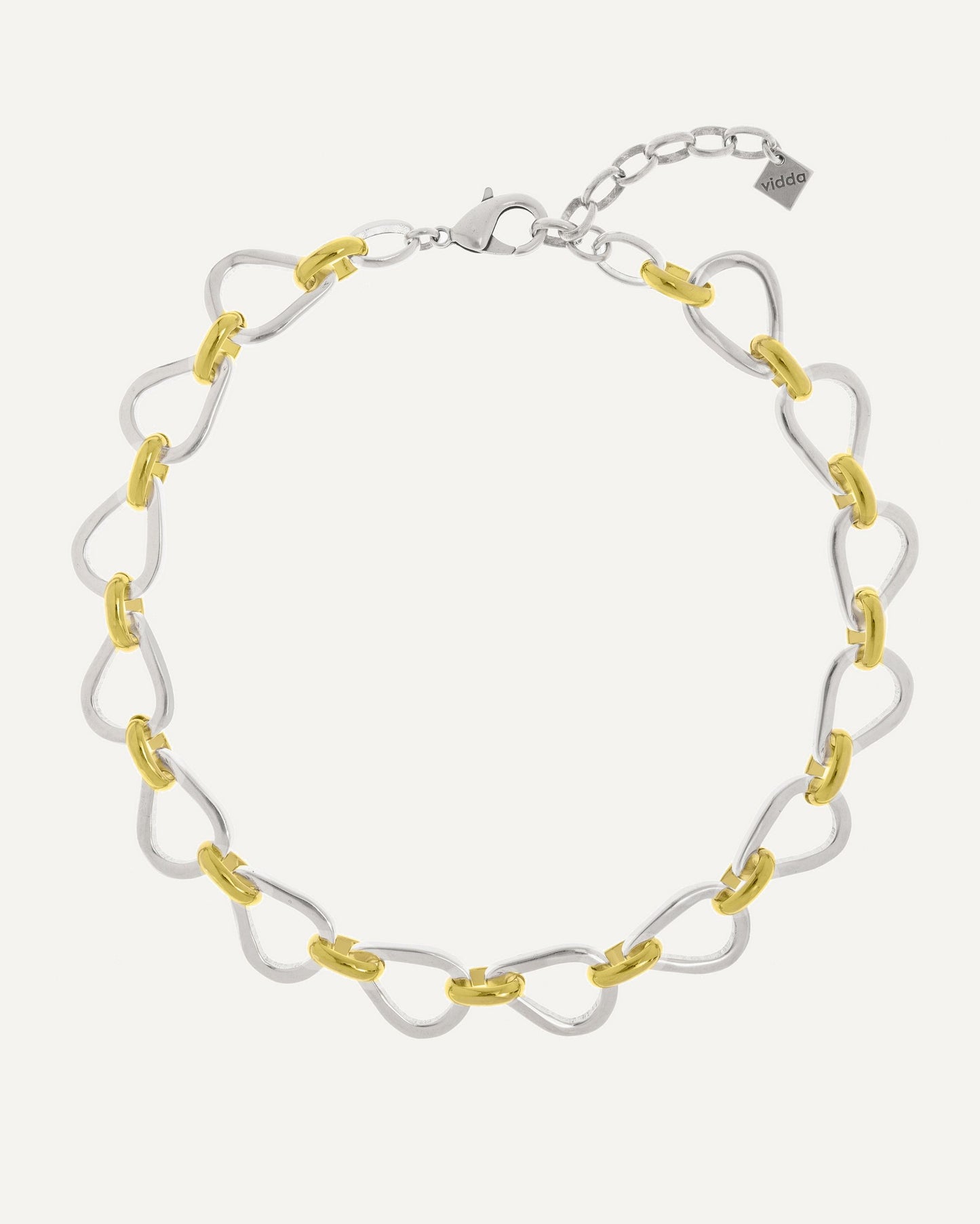 Short link necklace with teardrop-shaped links in mixed 24k gold and sterling silver. Vidda Jewelry product photo.