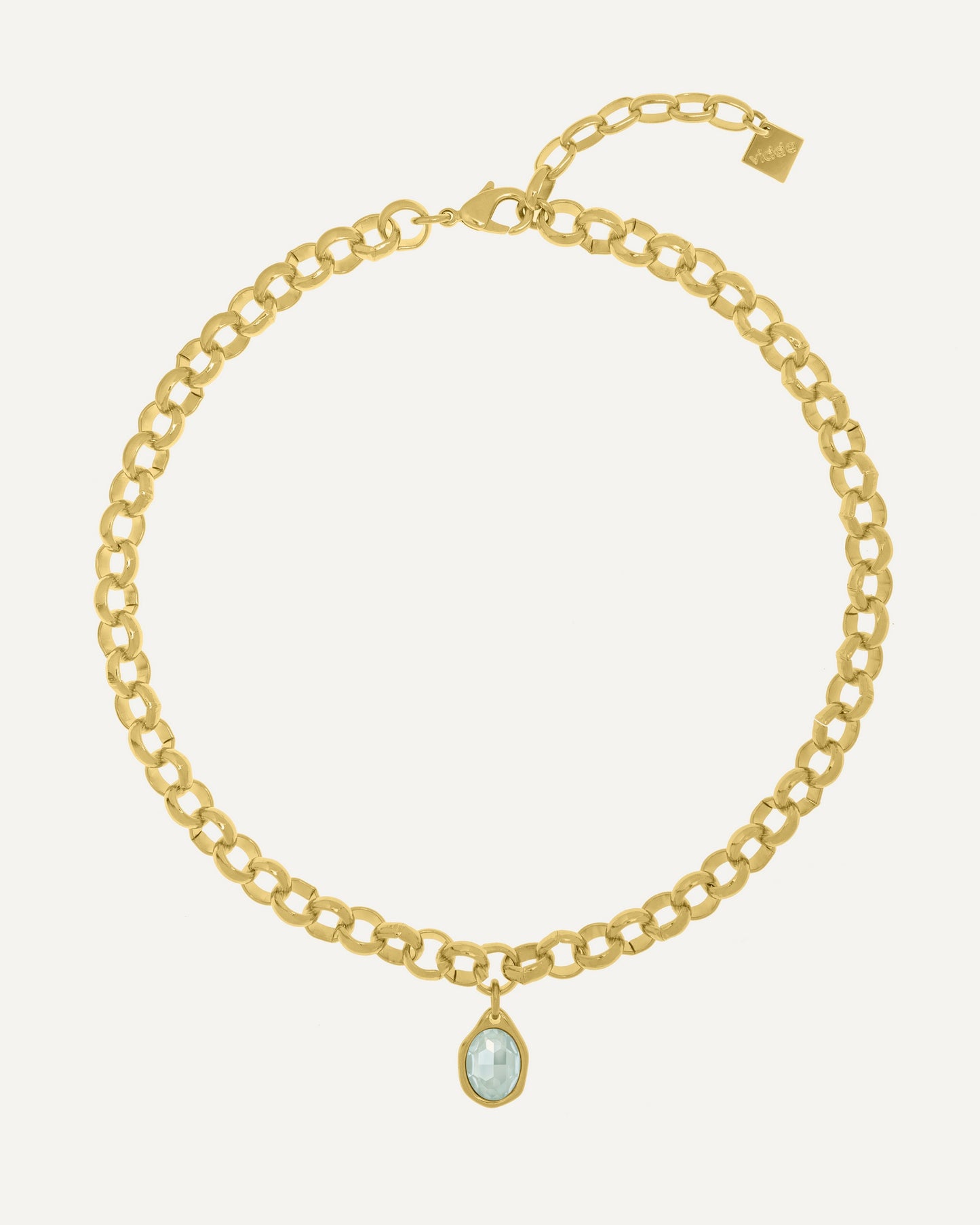 One of our best sellers: a gold-plated necklace with a short rolo chain and an oval Swarovski crystal charm.